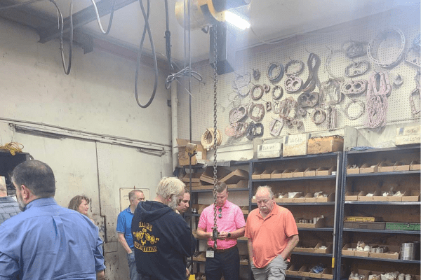technicians in a warehouse around compressor spare parts