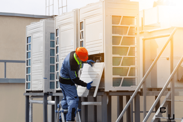 technician removing plate from commercial hvac