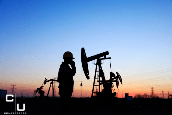 man standing in front of oil industry calling about a commercial compressor